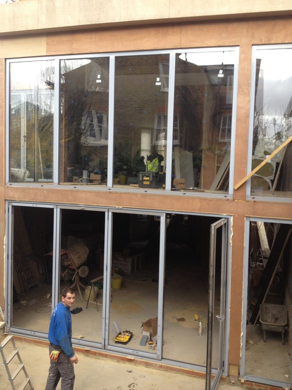 Aluminium bi-fold doors with two-storey glazing in Caterham