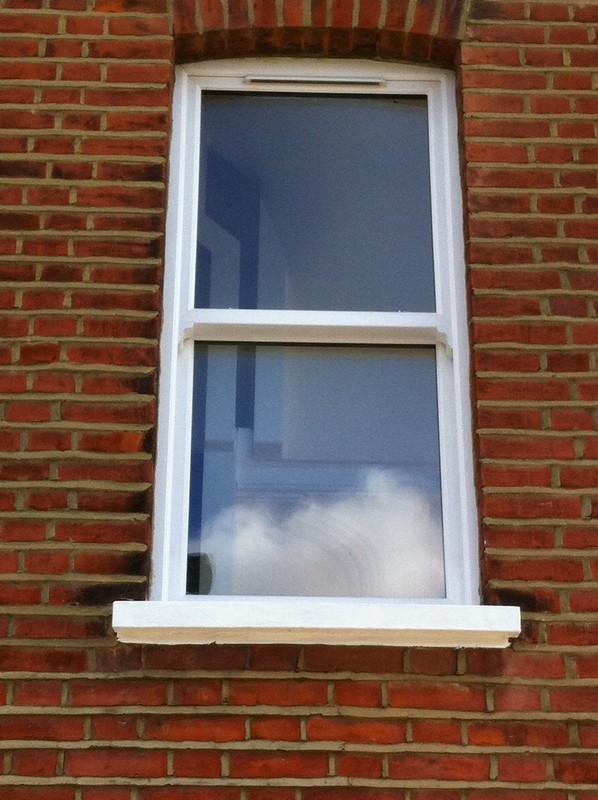 uPVC sash window on Victorian red brick house in Caterham